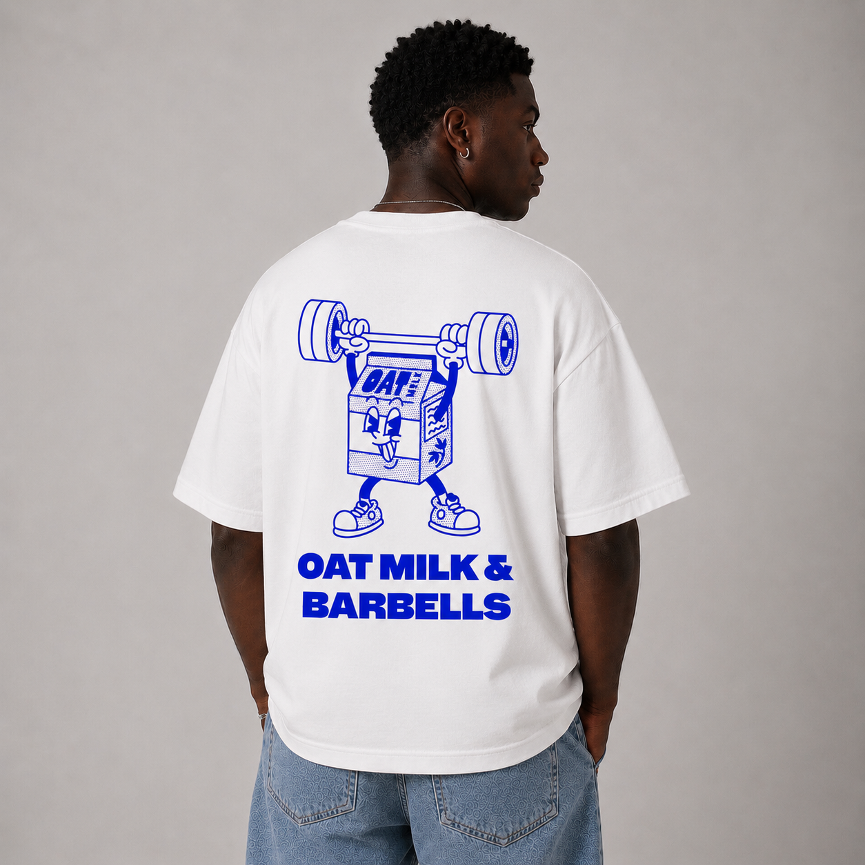 White Oversized T-Shirt Blue Backprint – Oat Milk Cartoon Mascot with Barbells. Vegan Gains Streetwear by Vegan Lifting Club
